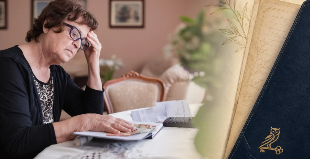 Older woman reviewing bills and financial documents as financial dignity becomes vulnerable.