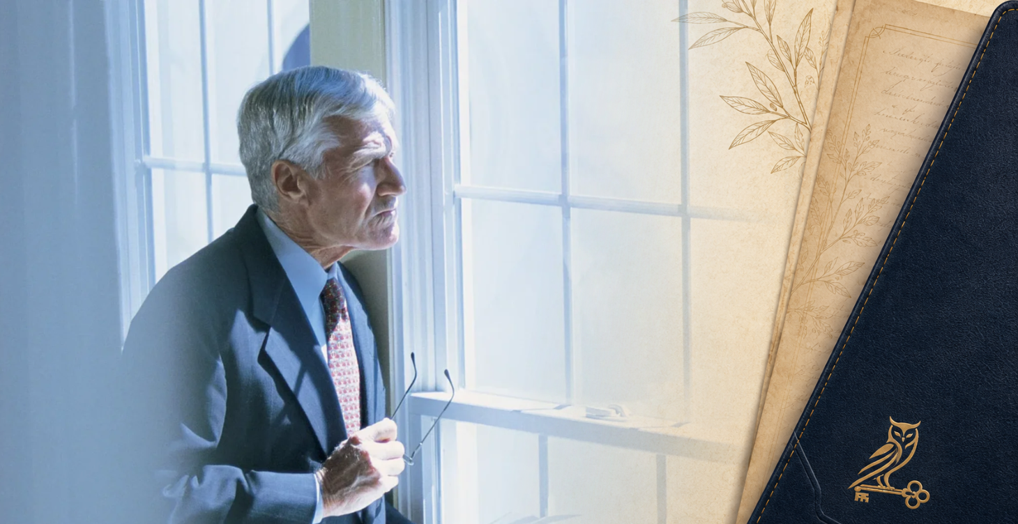 Older retired man looking out a window while adjusting to retirement and a quieter daily rhythm.